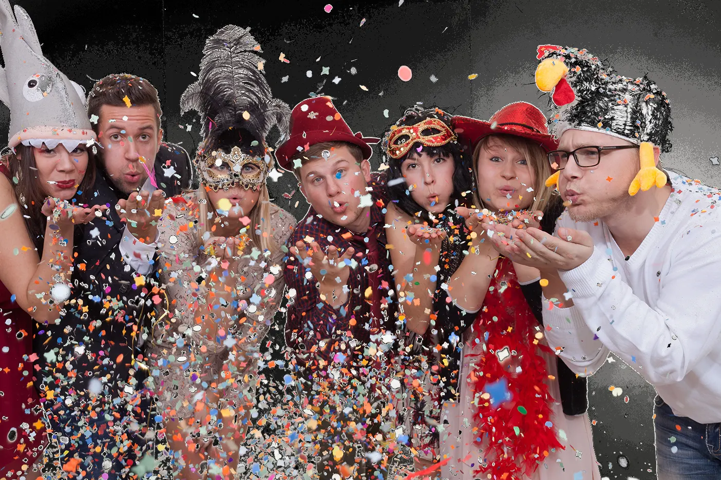 a group of people blowing confetti; Ein Gruppe Menschen blasen Konfetti